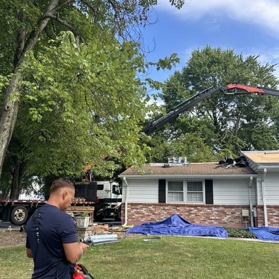 Boom truck lifting materials to a roof