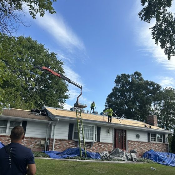 D&K crew on an exposed roof deck during a tear-off