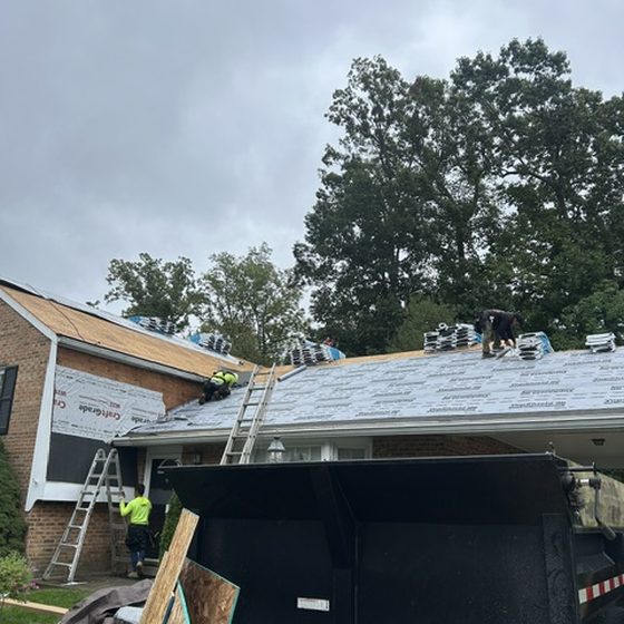 Synthetic underlayment installed with shingle bundles staged